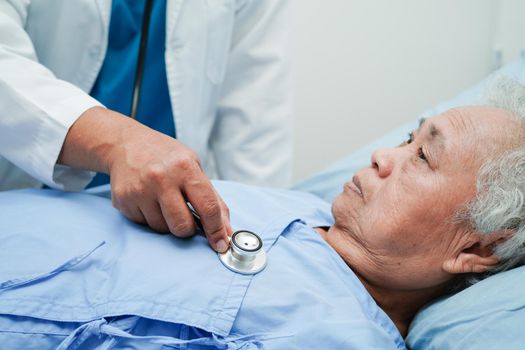 Asia doctor with stethoscope checking elderly woman patient in hospital, healthy medical concept.