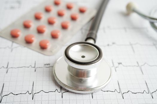 Stethoscope on electrocardiogram (ECG) with drug, heart wave, heart attack, cardiogram report.