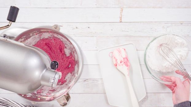 Flat lay. Preparing raspberry cream cheese buttercream in kitchen mixer for bake chocolate raspberry cupcakes.