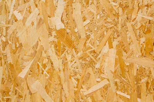 Pressed yellow wood chipboard background pattern texture. High quality photo