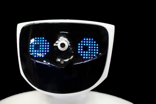 Robot face with electronic eyes on a black background.