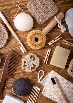 Top view of natural kitchen and bath products, zero waste living concept. Set of eco-friendly accessories: bamboo toothbrush, sisal brush, wooden cotton buds, soap bar, luffa, sponge konjac.