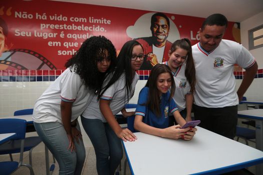 santana, bahia, brazil - september 13, 2022: students using smartphones in a classroom of a full-time state public school in the city of Santana.