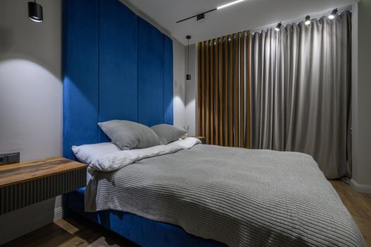 Cozy and luxury master bedroom in blue and grey colors with elegant and modern details