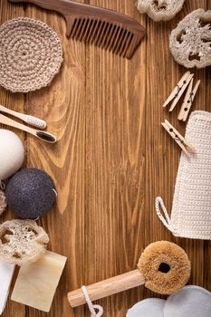Top view of natural kitchen and bath products, zero waste life concept. Set of eco-friendly accessories: bamboo toothbrush, sisal brush, wooden cotton buds, luffa, sponge konjac. Space for text