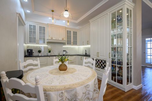 Modern classic white luxurious kitchen and dining room in studio apartment interior