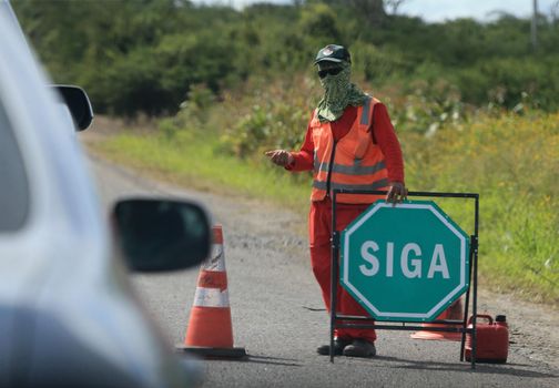 serra preta, bahia, brazil - september 13, 2022: workers recovering the BA 052 highway lane in the city of Serra Preta.