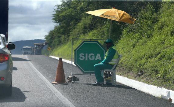 serra preta, bahia, brazil - september 13, 2022: workers recovering the BA 052 highway lane in the city of Serra Preta.