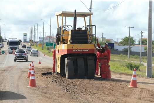 serra preta, bahia, brazil - september 13, 2022: workers recovering the BA 052 highway lane in the city of Serra Preta.