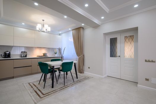 Modern classic white and beige luxurious kitchen with dining room in studio apartment interior