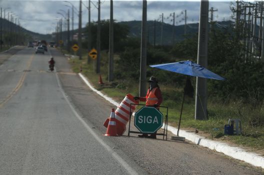serra preta, bahia, brazil - september 13, 2022: workers recovering the BA 052 highway lane in the city of Serra Preta.