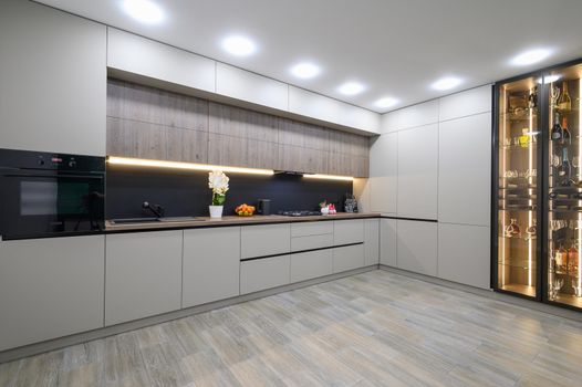 Trendy grey modern kitchen interior showcase with minimalistic furniture
