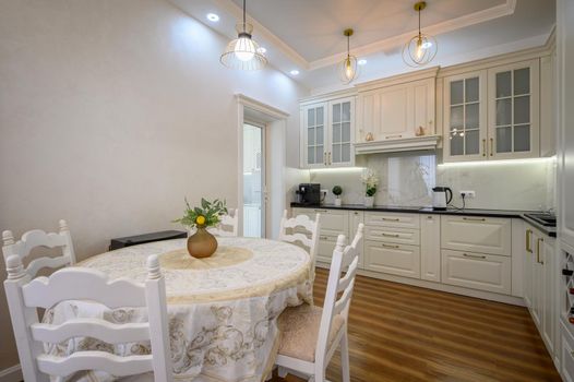 Modern classic white luxurious kitchen and dining room in studio apartment interior
