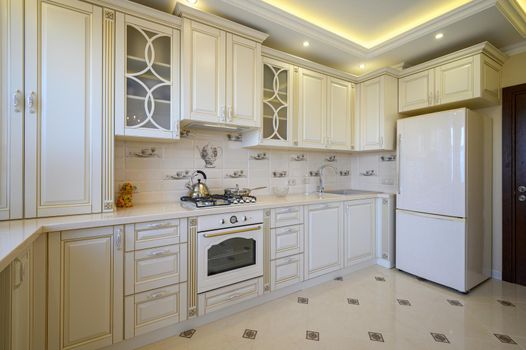 Classic white and beige luxurious kitchen in studio apartment interior