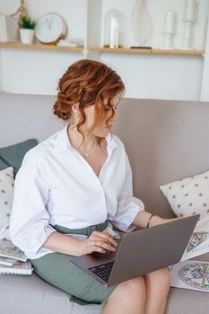 Tver, Russia-July 31, 2022 A woman with a laptop is studying human design. The concept of studying esoteric sciences. Studying rave postcards from human design.