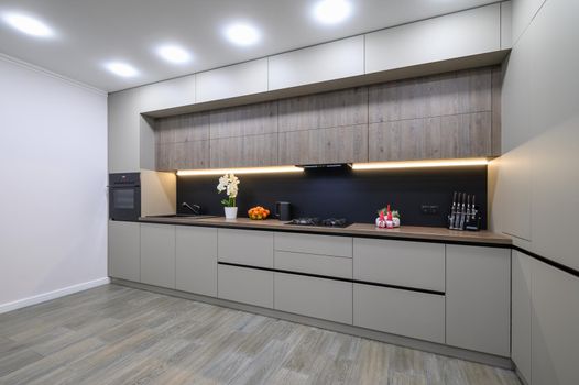 Trendy grey modern kitchen interior showcase with minimalistic furniture