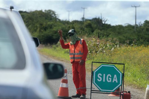 serra preta, bahia, brazil - september 13, 2022: workers recovering the BA 052 highway lane in the city of Serra Preta.