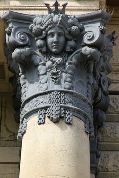 Metal column ornament with carved portrait of a woman. Szechenyi Bath Budapest, Hungary.