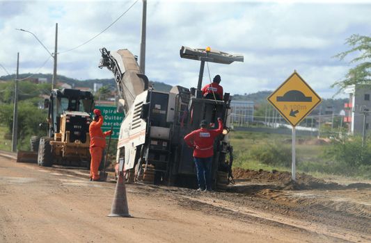 serra preta, bahia, brazil - september 13, 2022: workers recovering the BA 052 highway lane in the city of Serra Preta.
