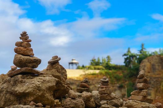 stacked stone monticule sky with clouds and in the background viewpoint of ronda