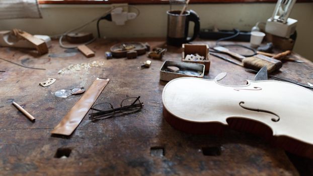 violinmaker at work in his italian workshop