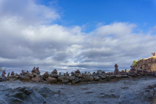 stacked stone monticule sky with clouds and in the background viewpoint of ronda