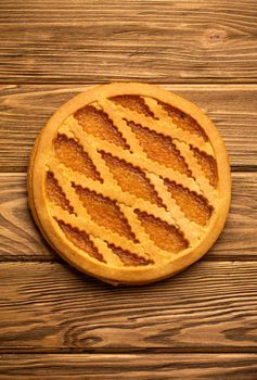 Pumpkin pie on rustic wooden background. Traditional American autumn, Thanksgiving and Halloween sweet pie, seasonal fall dessert. Close up, top view.