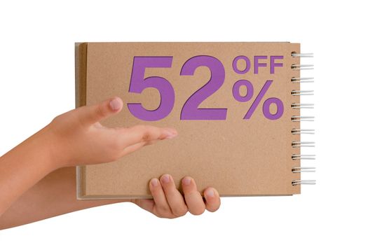 52 percent discount on isolate. Notepad from recycled paper in the hands of a child with text, sale up to 52 percent. The child is holding a notepad demonstrating a big sale