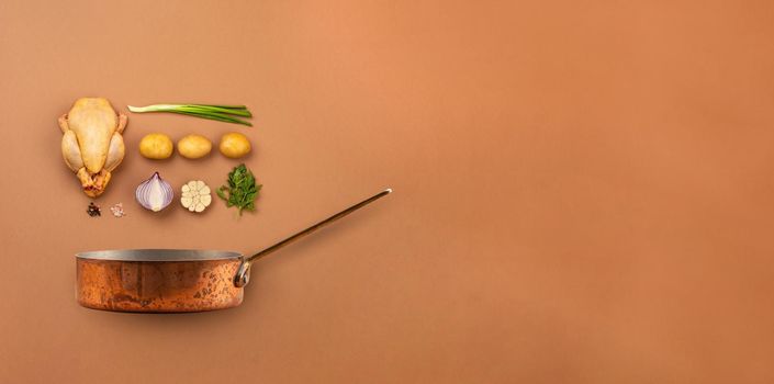 Set of raw ingredients arranged for cooking chicken soup or stew in copper pot: chicken, potatoes, vegetables on brown background from above. Healthy meal with poultry for dinner, space for text