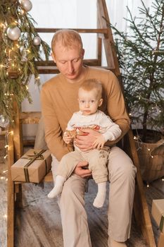 Dad and his little son in a magical Christmas atmosphere. The concept of family relations and New Year celebrations