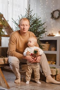 Dad and his little son in a magical Christmas atmosphere. The concept of family relations and New Year celebrations