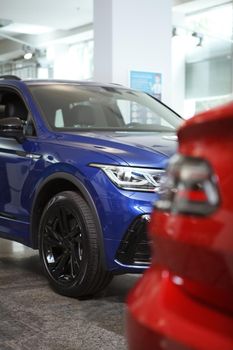 Vertical cropped shot of new automobiles at car dealership