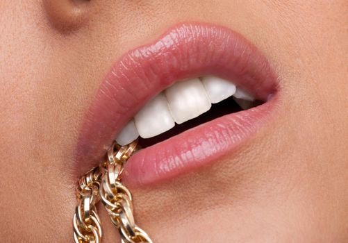 Beauty sexy woman lips desired with gold chain close-up shot