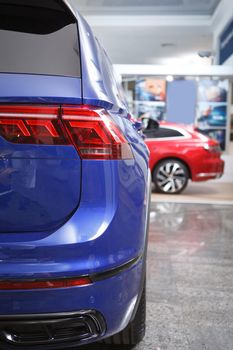 Vertical cropped shot of new automobile at car dealership salon