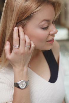 Cropped vertical close up of a woman trying on diamond ring
