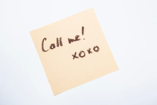 Yellow sticky note with handwritten call me memo