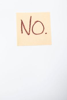 Vertical shot of a no text written on yellow sticky note