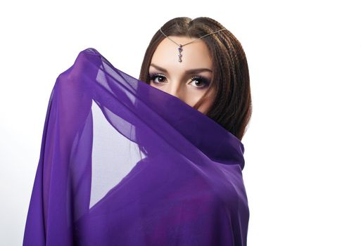 Beauty woman close face by purple cloth with jewels on head