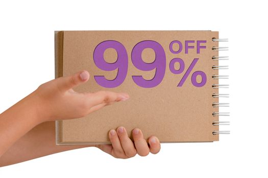 99 percent discount on isolate. Notepad from recycled paper in the hands of a child with text, sale up to 99 percent. The child is holding a notepad demonstrating a big sale