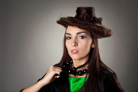 Beauty brunette woman portrait with hair style hat in green suit and black jacket