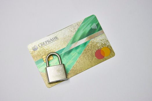 Russia, Syzran - FEBRUARY 27, 2022: sanctions against Sberbank. bank card under lock and key.