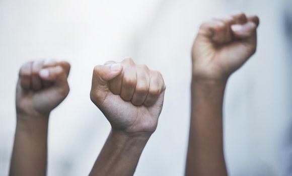 Fist hands to protest, rally and justice from government law, corruption and politics for freedom, power and human rights equality. Crowd of people fight for global revolution, change and stop racism.