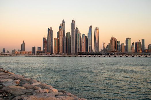 View of A Dubai Marina during sunset hour. Shot made from Palm Jumeirah, man made island. Dubai, UAE. Outdoors.