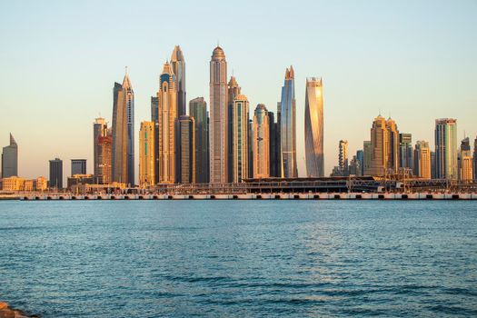 View of A Dubai Marina during sunset hour. Shot made from Palm Jumeirah, man made island. Dubai, UAE. Outdoors.