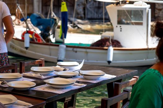 Table prepared in a restaurant by the Mediterranean Sea