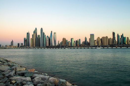 View of A Dubai Marina during sunset hour. Shot made from Palm Jumeirah, man made island. Dubai, UAE. Outdoors.