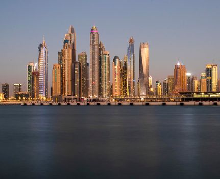View of A Dubai Marina after sunset. Shot made from Palm Jumeirah, man made island. Dubai, UAE. Outdoors.