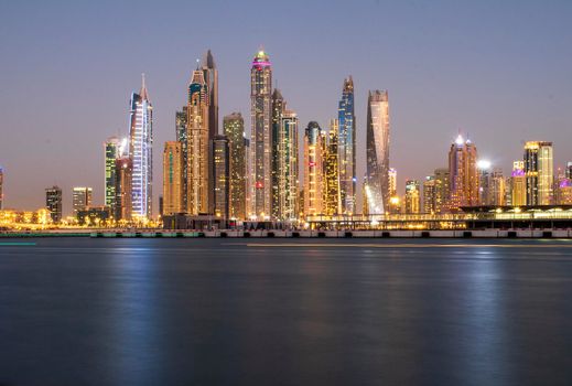 View of A Dubai Marina after sunset. Shot made from Palm Jumeirah, man made island. Dubai, UAE. Outdoors.