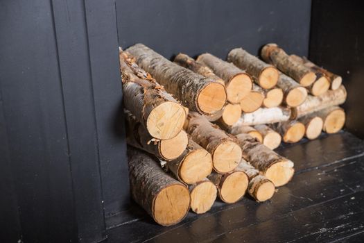 Stock of firewood for heating the house. The trees were cut down and split into firewood to be used as heating fuel in fireplaces and stoves,