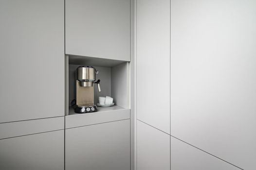Modern gray kitchen corner with espresso coffee machine, concept photo, lot of copy space